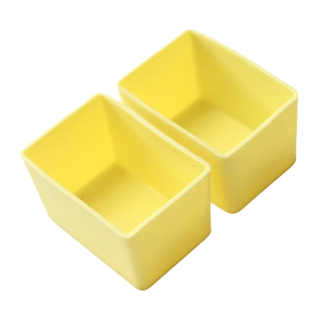 Yellow lemon silicone Munch Cups Rectangle , used to separate snacks neatly on a white background.