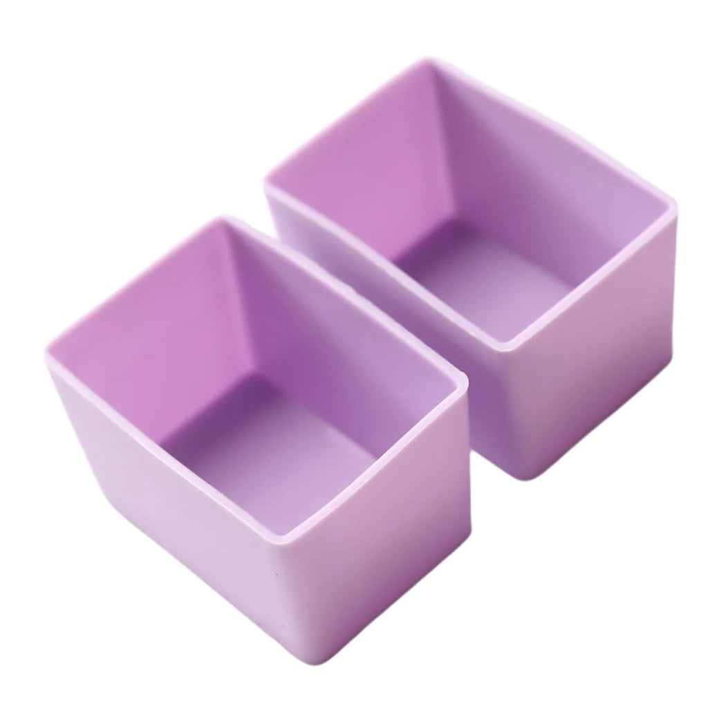 Purple silicone Munch Cups Rectangle  used to separate snacks neatly on white background.