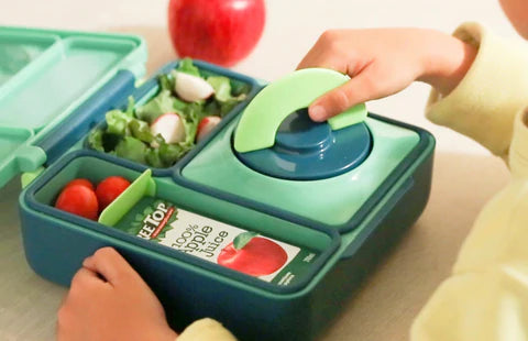 Child using the Meadow OmieBox V2 leakproof bento lunch box, a popular choice in Australia
