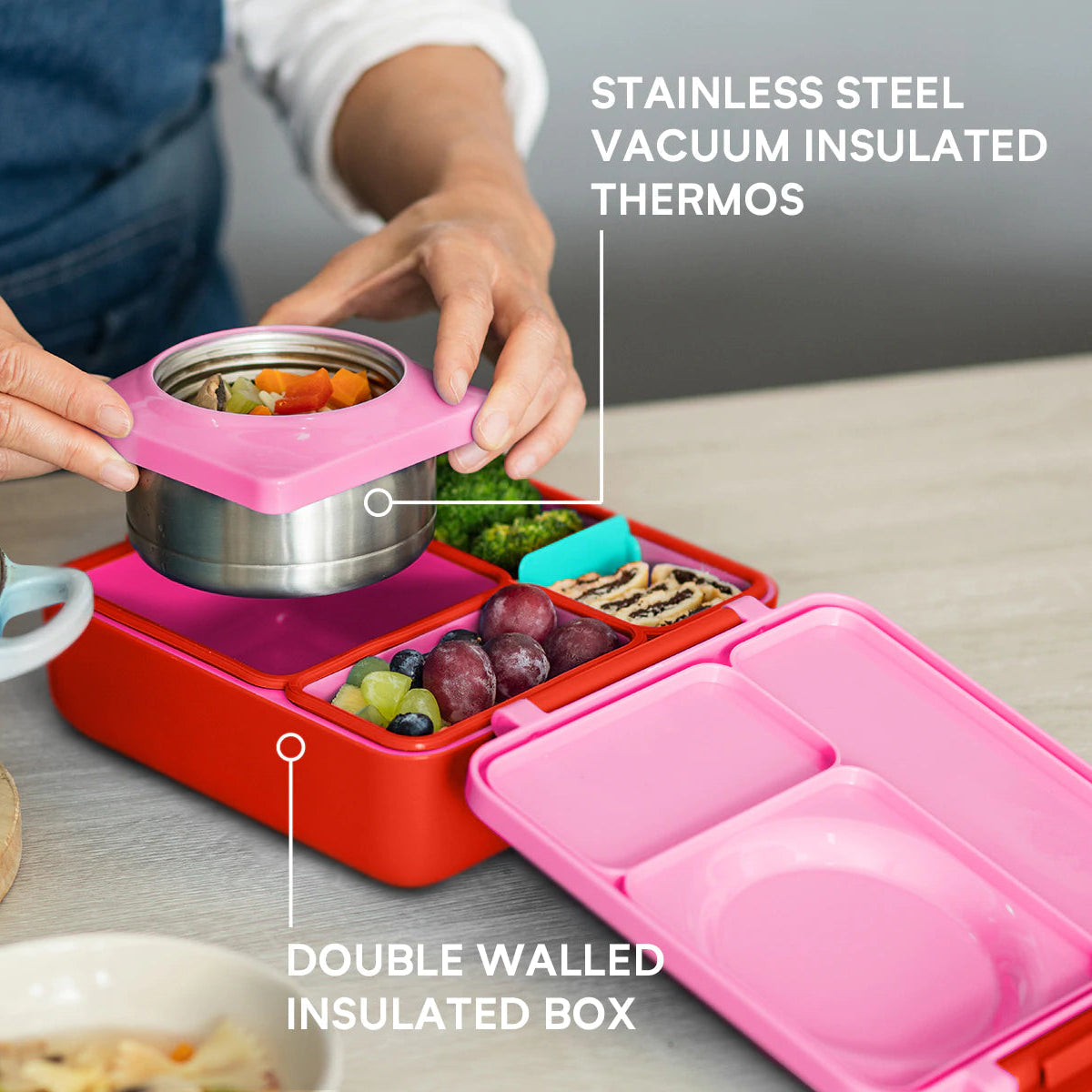 Child using the Pink Berry OmieBox V2 leakproof bento lunch box, a popular choice in Australia.