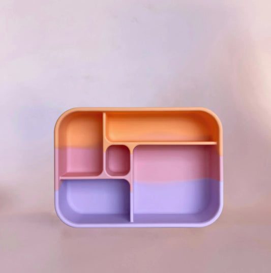 A silicone Bento lunchbox with multiple compartments in orange, pink, and blue colors.